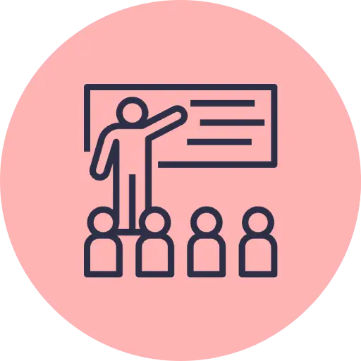 Icono de formador impartiendo formación presencial a un grupo de alumnos en aula